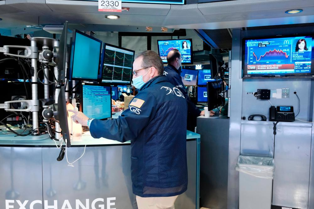Traders working on the floor of the New York Stock Exchange. In December, the SEC mandated that Chinese companies listed on US stock exchanges must disclose whether they are owned or controlled by a government entity, and provide evidence of their auditing inspections. – AFPpix