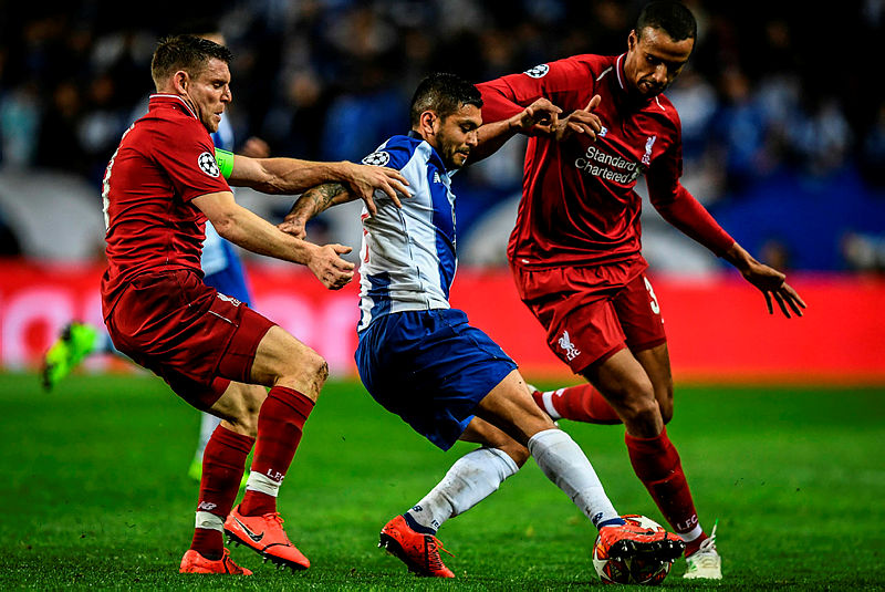 Porto’s Jesus Corona (C) battles with Liverpool’s Joel Matip (R) and James Milner during their UEFA Champions League quarter-final second leg at the Dragao in Porto on April 17, 2019. — AFP