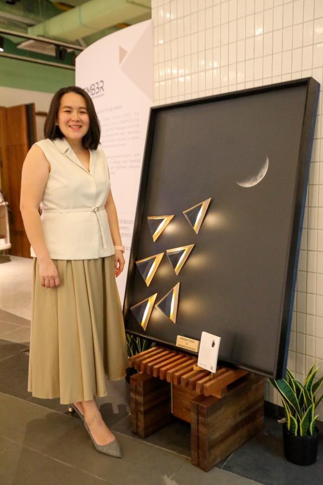 Ng with her unique wall lights creation that looks like an artpiece from her Prism Decorative Lighting series. – PICS BY AMIRUL SYAFIQ/THESUN