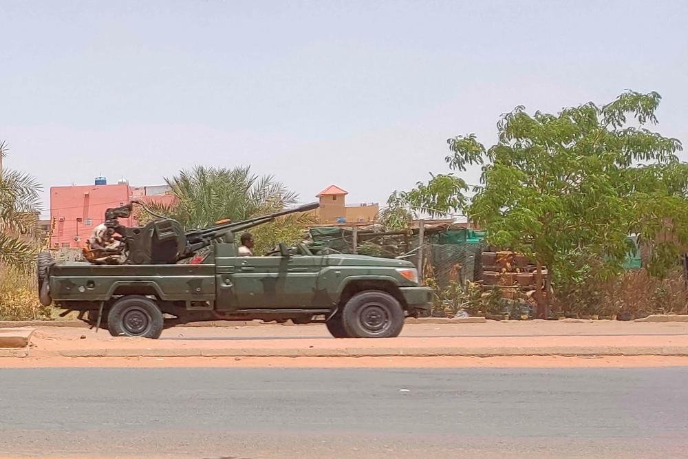 A military vehicle, belonging to the paramilitary Rapid Support Forces (RSF), drives down a street in southern Khartoum on May 25, 2023. AFPPIX