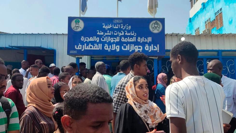 Sudanese queue outside a passport office in Gedaref, desperate to renew the travel documents that will allow them to flee the fighting gripping the country. AFPPIX