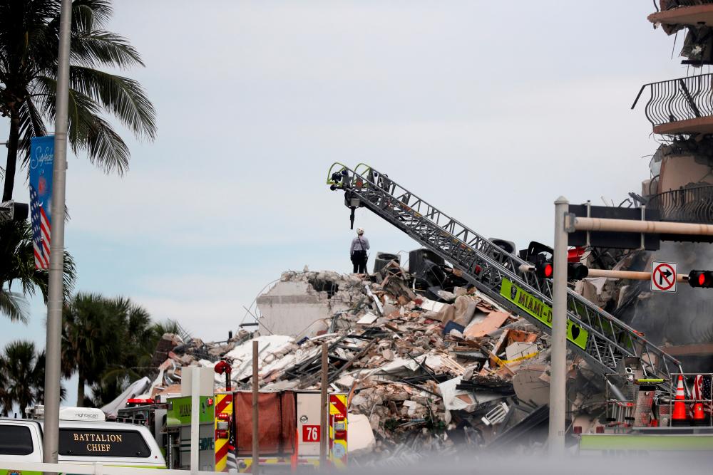 Emergency crew members search for missing residents in a partially collapsed building in Surfside, near Miami Beach, Florida, U.S., June 24, 2021. — Reuters