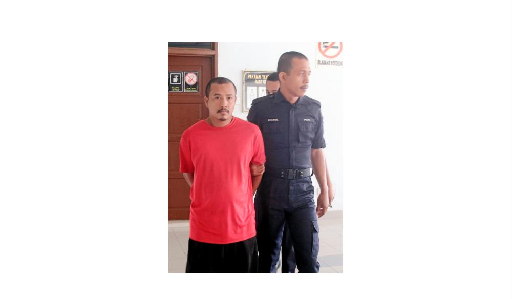 The suspect is led out of the Alor Gajah sessions court, on Oct 3, 2019. — BBX-Images