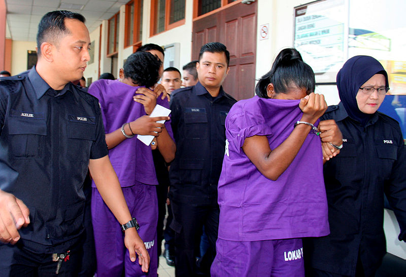 The suspects are led out of the Taiping magistrate’s court, on July 8, 2019. — Bernama