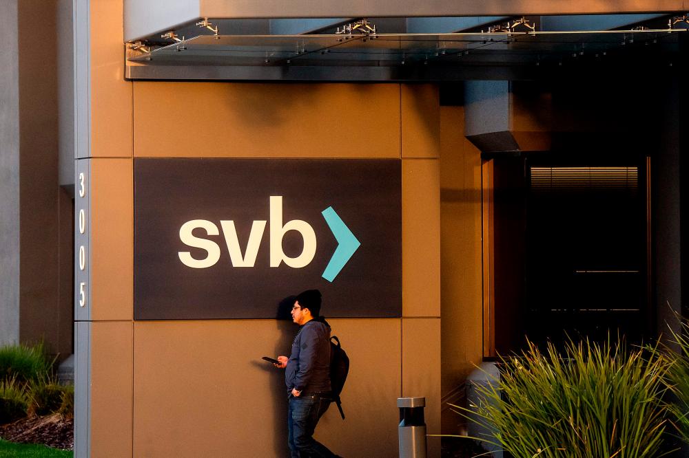 A man passes a sign Silicon Valley Bank’s headquarters in Santa Clara, California, on Monday, March 13, 2023. – AFPpic