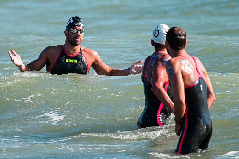 Italy's Dario Verani (L) reacts after competing in the Open Water Mixed 25km event, on August 20, 2022 at Lido di Ostia, southwest of Rome, during the LEN European Aquatics Championships. - AFPPIX