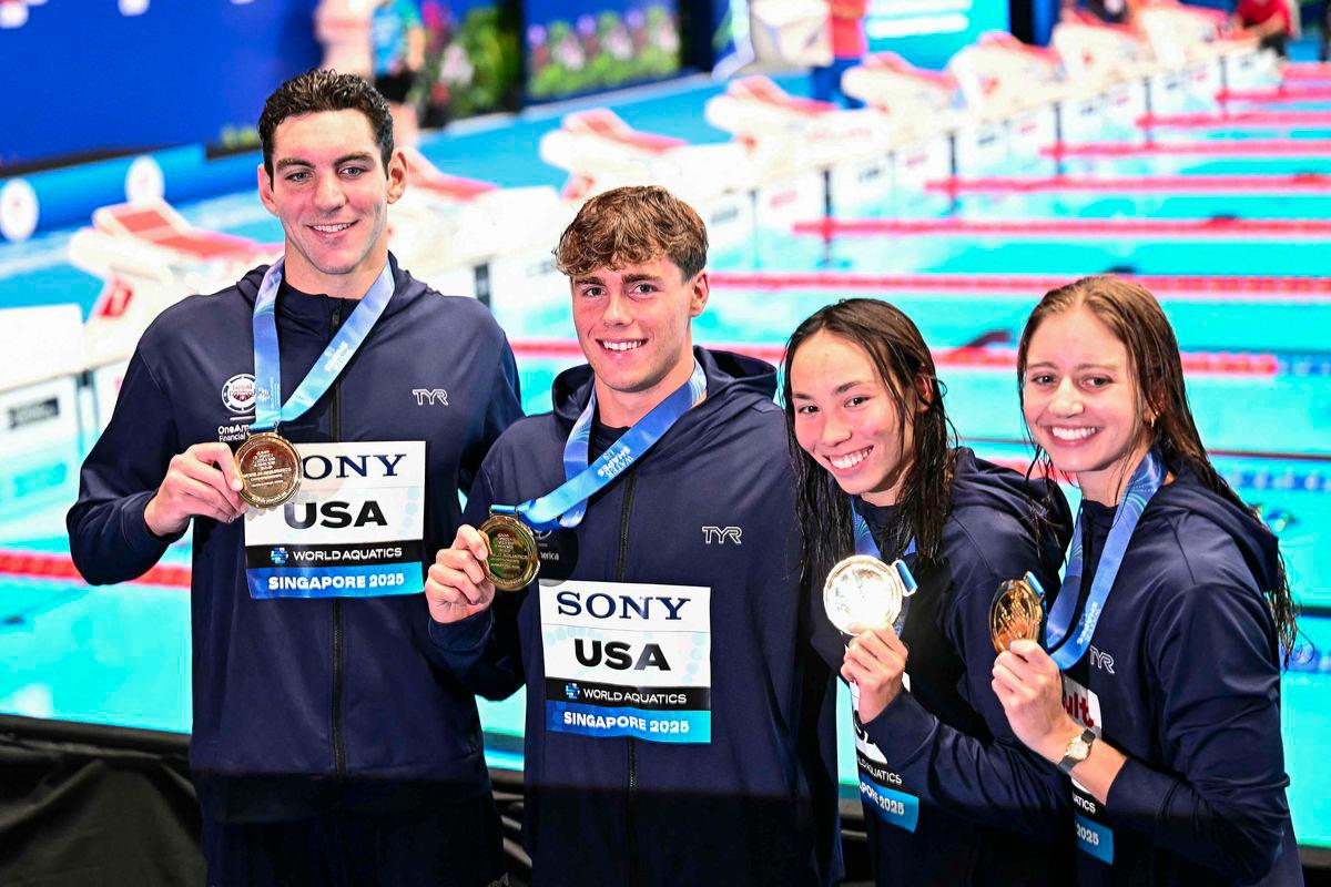 (From L) Gold medallists US' swimmer Jack Alexy, US' swimmer Patrick Sammon, US' swimmer Kate Douglass and US' swimmer Torri Huske celebrate on the podium of the mixed 4x100m freestyle relay swimming event during the 2025 World Aquatics Championships in Singapore on August 2, 2025. - AFPPIX