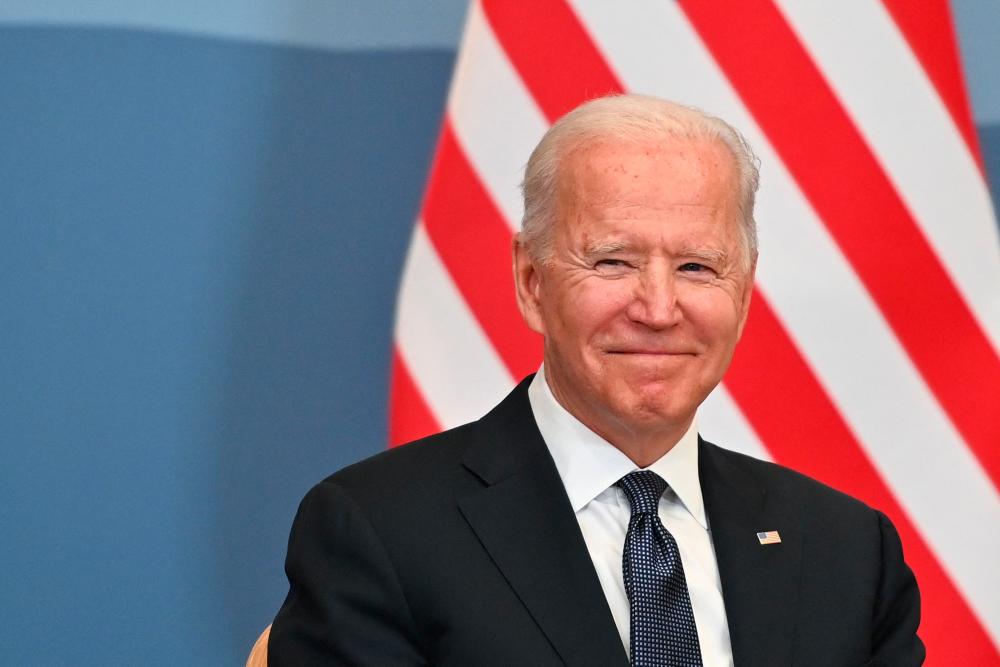 US President Joe Biden smiles during a bilateral meeting with Swiss president of the Swiss confederation and in Geneva on June 15, 2021. – AFP