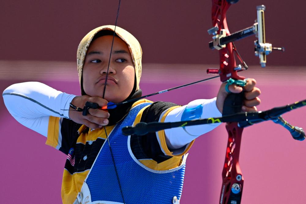 Malaysia’s Syaqiera Mashayikh competes in the womens’s individual eliminations during the Tokyo 2020 Olympic Games at Yumenoshima Park Archery Field in Tokyo July 27, 2021. — AFP