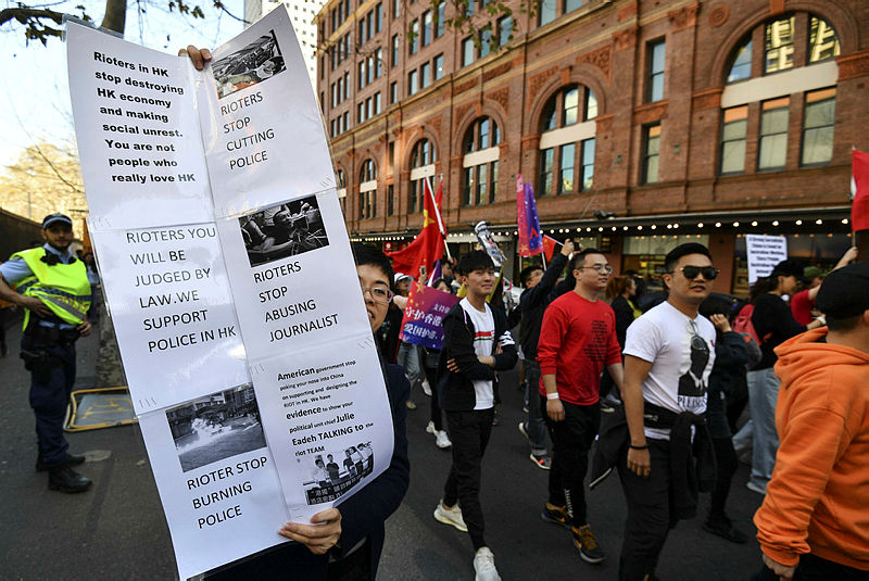 Pro-China activists march on the streets of Sydney on Aug 17, 2019, as they rally against ongoing protests in Hong Kong. — Bernama