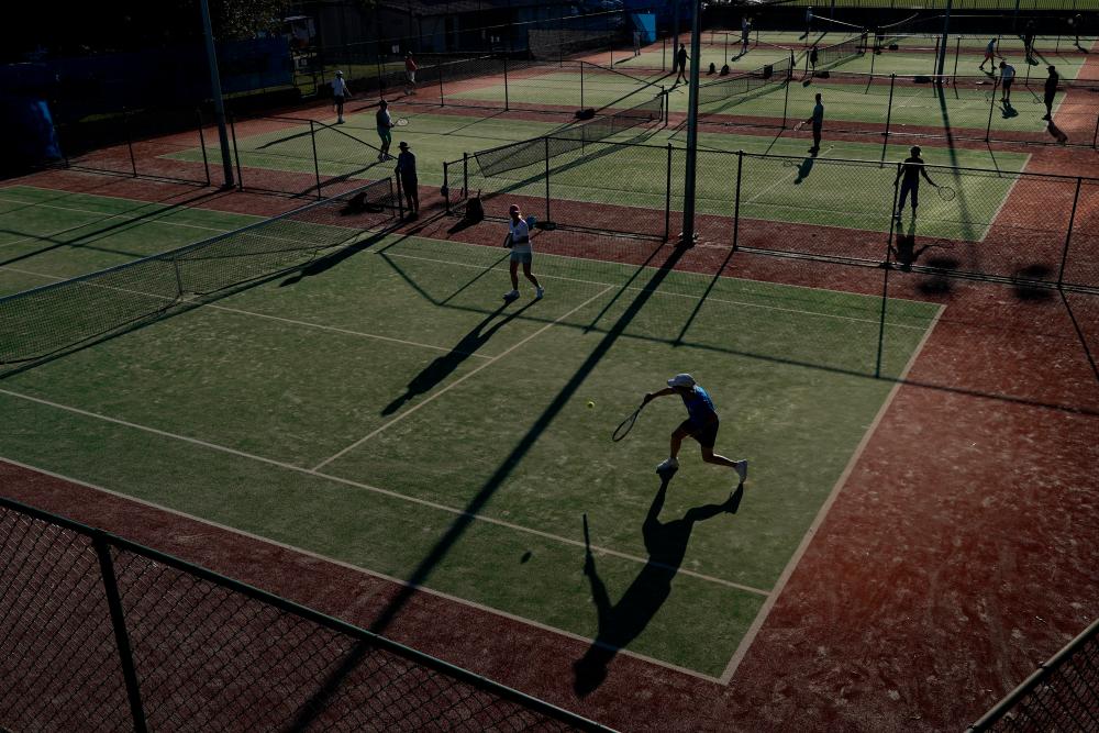 People play tennis next to Coogee Beach in the wake of the coronavirus disease (Covid-19) regulations easing, following months of lockdown orders to curb an outbreak, in Sydney, Australia, October 18, 2021. REUTERSpix