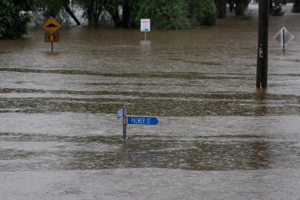 A street sign is seen just above the water's surface in the suburb of Windsor as the state of New South Wales experiences widespread flooding and severe weather, in Sydney, Australia, March 22, 2021. — Reuters