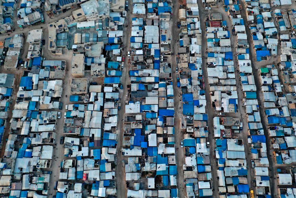 An aerial picture shows a view of a displacement camp near the village of Qah in Syria’s northwestern Idlib province, by the Turkish border, on March 3, 2021. - AFP