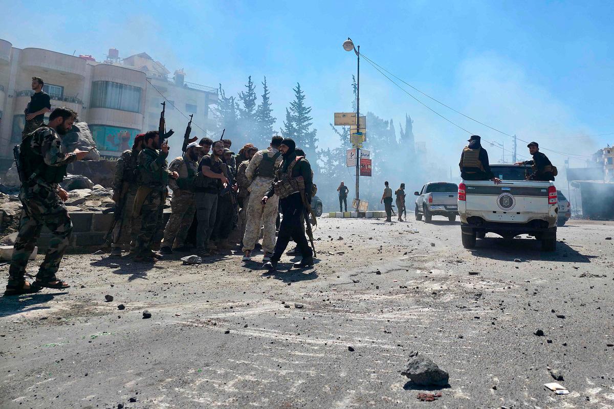 Syria's security forces enter the predominantly Druze city of Sweida on July 15, 2025, following clashes between Bedouin tribes and Druze fighters. Syrian government forces entered the majority Druze city of Sweida on July 15, 2025, the interior ministry said, aiming to end clashes with Bedouin tribes that have killed nearly 100 people. - Sam HARIRI / AFP