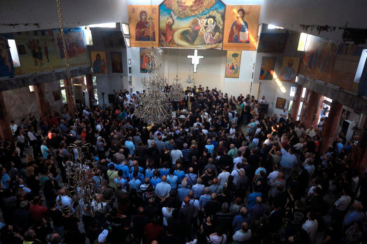 Worshippers gather for a mass led by the Greek Orthodox Patriarch of Antioch at the Saint Elias Church, the day after a suicide attack on this religious site, in Damascus’ Dwelaa area, on June 23, 2025. (Photo by Bakr ALKASEM / AFP)