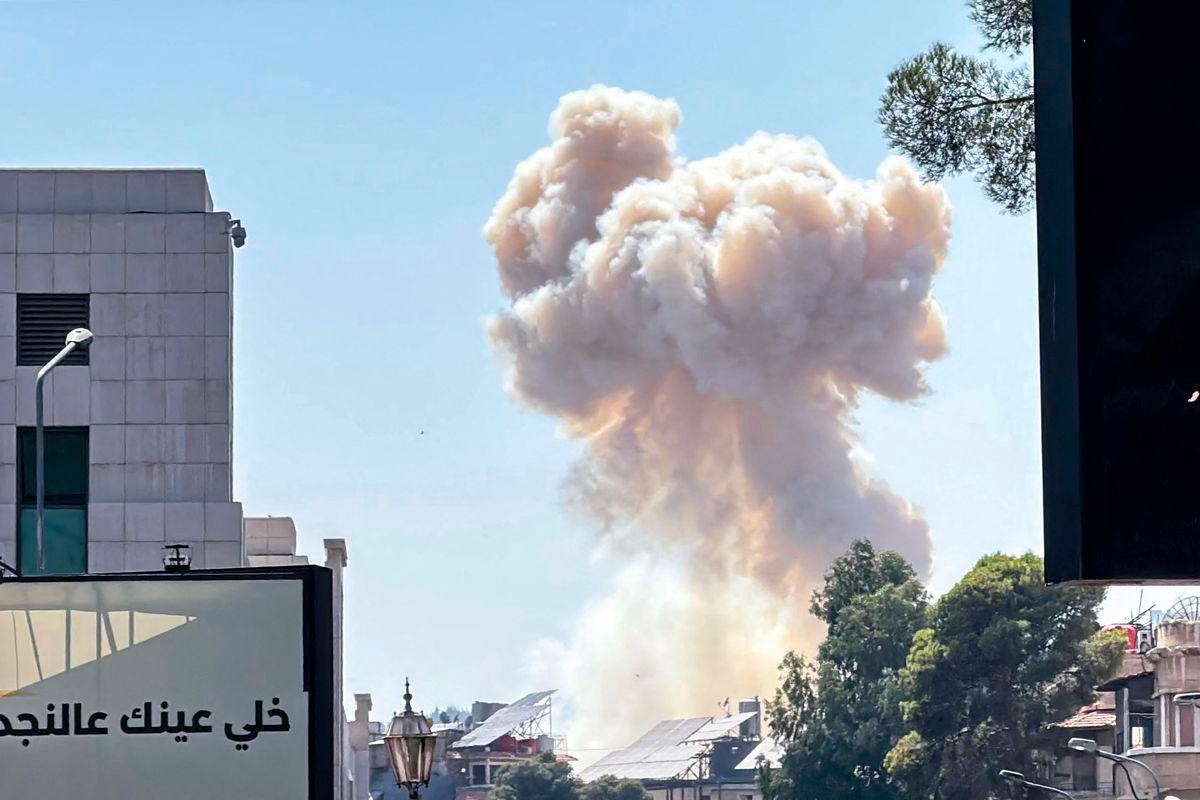 Smoke billows following Israeli strikes near the Syrian army and defence ministry headquarters in Damascus on July 16, 2025. (Photo by Rami al SAYED / AFP)