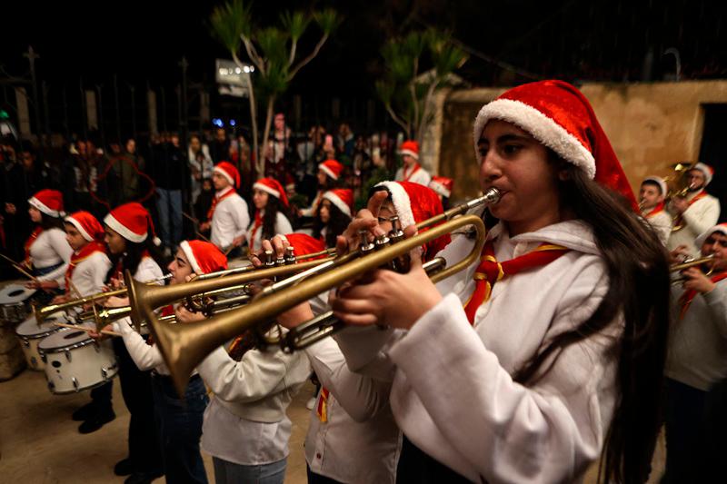 $!Syrian scouts play music following Christmas Eve mass at The Church of the Sacred Heart of Jesus in the port city of Latakia on December 24, 2024. Syria's rulers who toppled Assad's government on December 8 have since sought to assure religious and ethnic minorities that their rights would be upheld. But for some in the Christian community of several hundred thousands, the promises made by the new Islamist leadership have done little to soothe their fears in a country scarred by years of civil war. (Photo by AAREF WATAD / AFP)