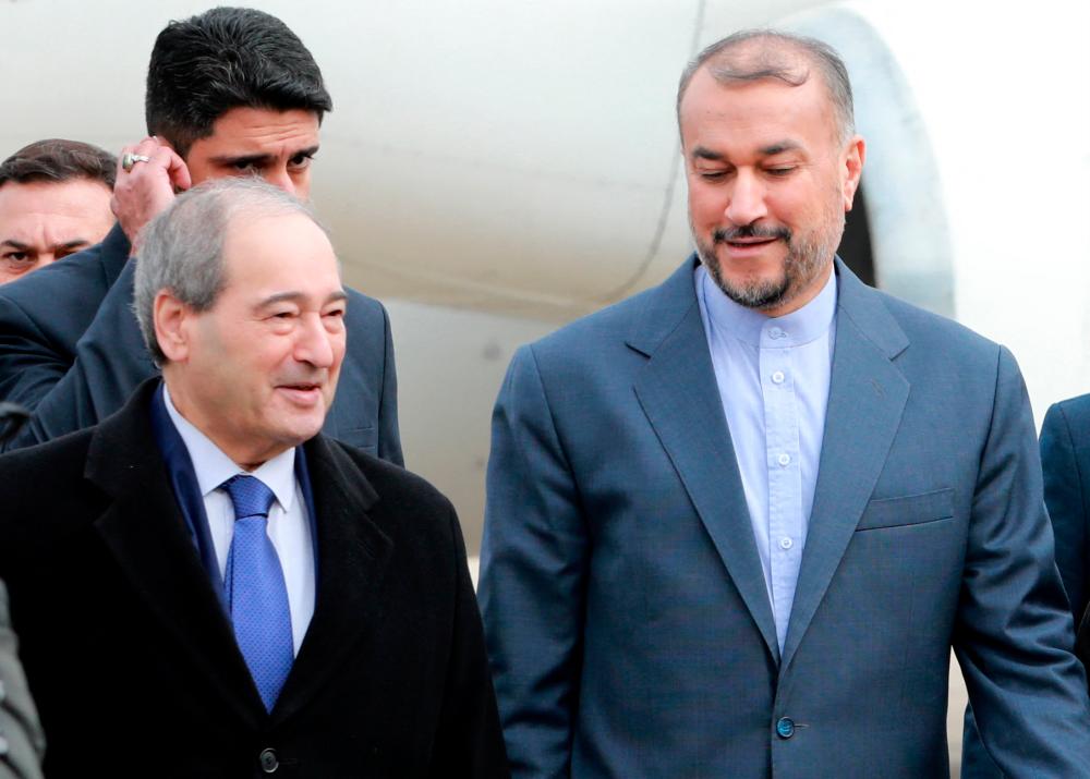 Syrian Foriegn Minister Faisal Mekdad (L) welcomes his Iranian counterpart Hossein Amir-Abdollahian (R) at Damascus airport on January 14, 2023. Amir-Abdollahian arrived in the Syrian capital after a visit to neighbouring Lebanon at a time of warming ties between Syria and Turkey. AFPPIX