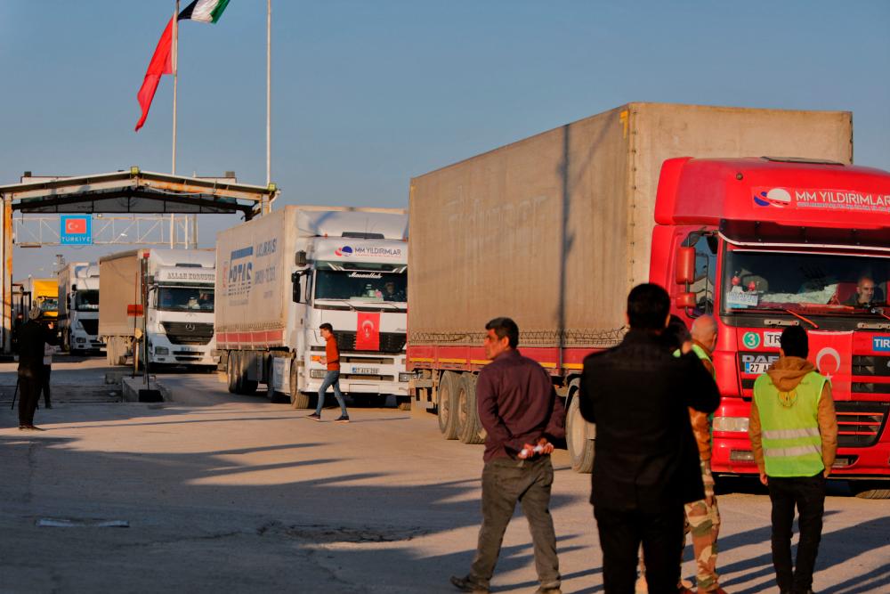 Trucks part of an aid convoy cross from Turkey into rebel-held north Syria through the Bab al-Salama crossing on February 14, 2023, after it reopened for UN relief after last week’s earthquake. AFPPIX