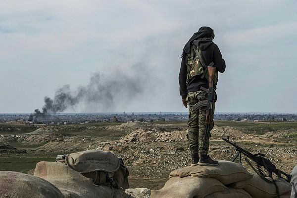 A fighter with the US-backed Syrian Democratic Forces (SDF) keeps position during an operation to expel Islamic State group (IS) jihadists from the Baghouz area. — AFP
