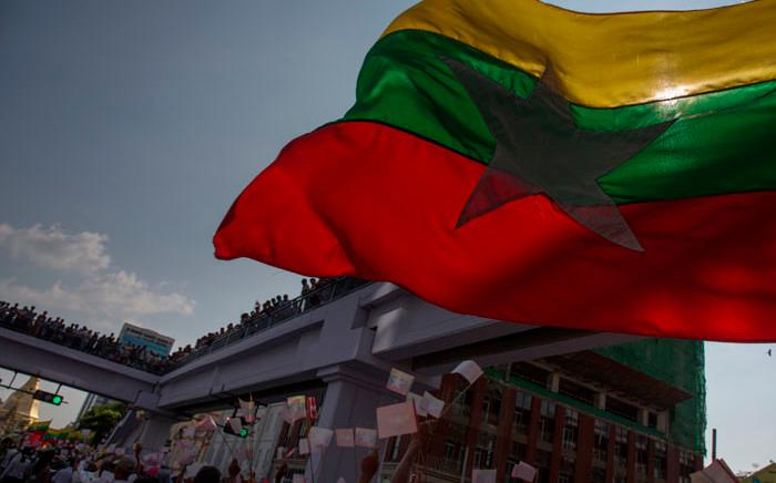 The Myanmar flag flies during a march in Yangon. AFPPIX