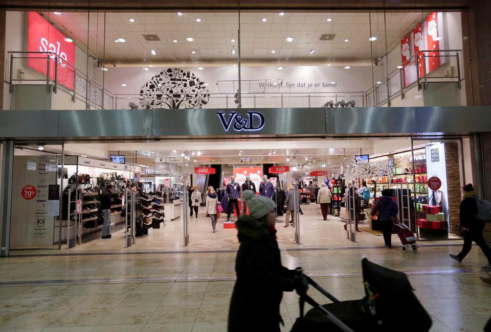 Shoppers pass by under sale signs at a Vroom &amp; Dreesmann (V&amp;D) department store in Utrecht, the Netherlands January 19, 2016. REUTERSPIX