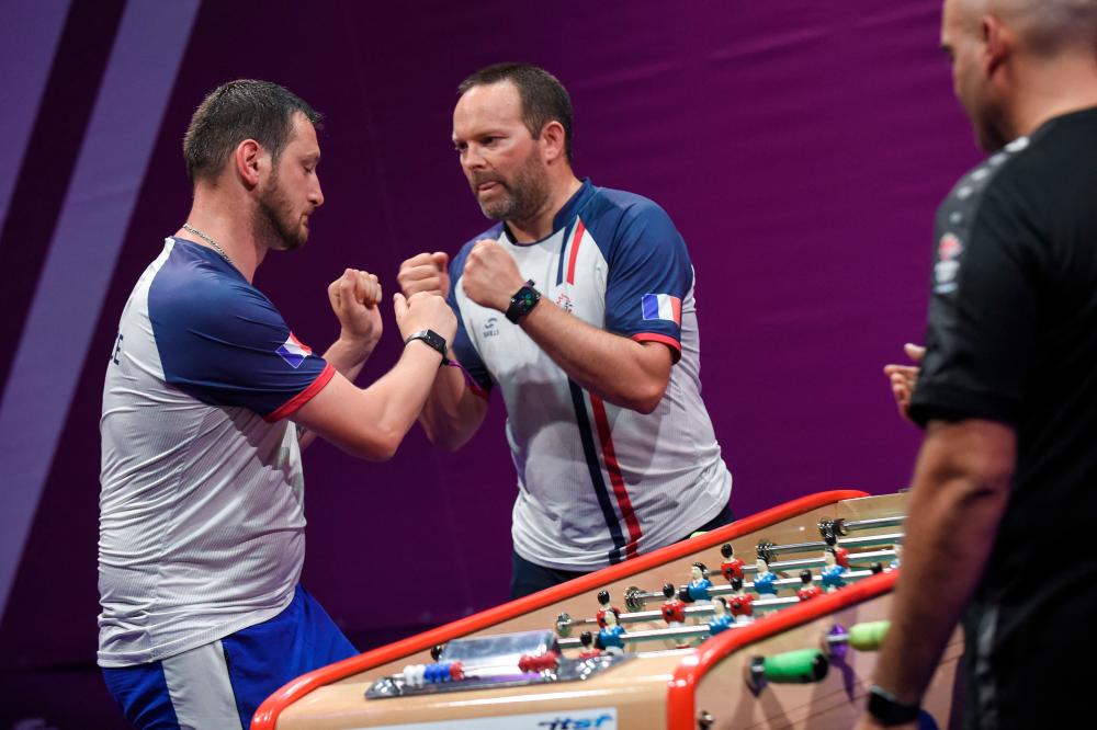 French players react during a match against Luxembourg at the 2022 ITSF table soccer World Cup in Nantes, Western France, on June 28, 2022. AFPPIX