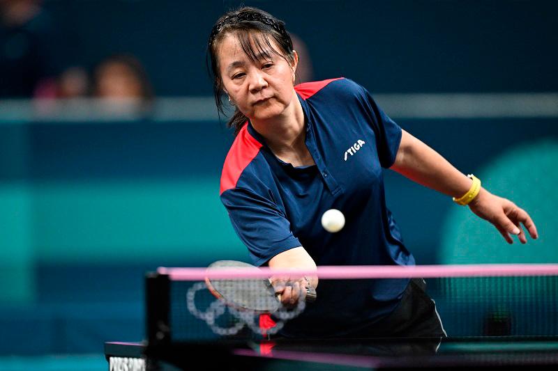 Chile’s Zhiying Zeng plays a return to Lebanon’s Mariana Sahakian during their women’s table tennis singles preliminary round at the Paris 2024 Olympic Games at the South Paris Arena in Paris on July 27, 2024. - (Photo by JUNG Yeon-je / AFP)