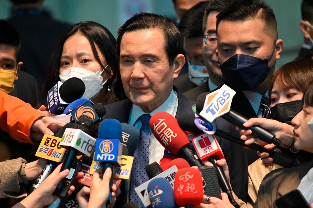 Taiwan’s former president Ma Ying-jeou (C) speaks to journalists before his visit to China from the Taoyuan international airport on March 27, 2023. AFPPIX