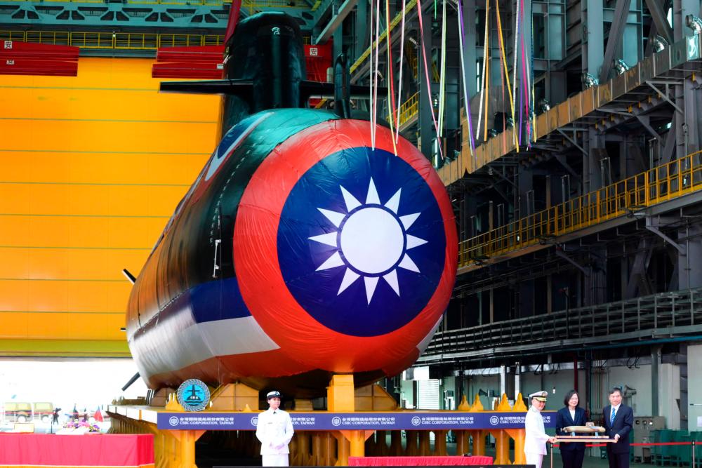 Taiwan President Tsai Ing-wen (2nd R) receives a submarine model in front of Taiwan’s first locally built submarine during the vessel’s unveiling ceremony at the CSBC Corporation shipbuilding company in Kaohsiung on September 28, 2023/AFPPix