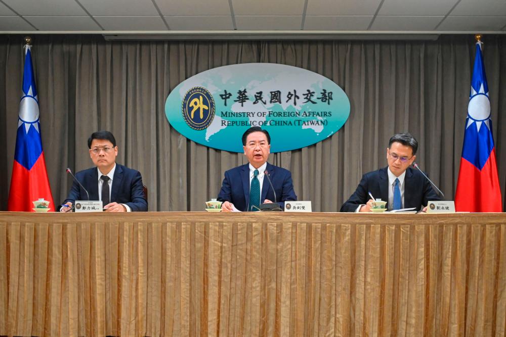 Taiwan’s Foreign Minister Joseph Wu (C), head of the Ministry of Foreign Affairs’ Department of Latin American and Caribbean Affairs Cheng Li-cheng (L), and Spokesman Jeff Liu (R) attend a press conference in Taipei on March 26, 2023. AFPPIX
