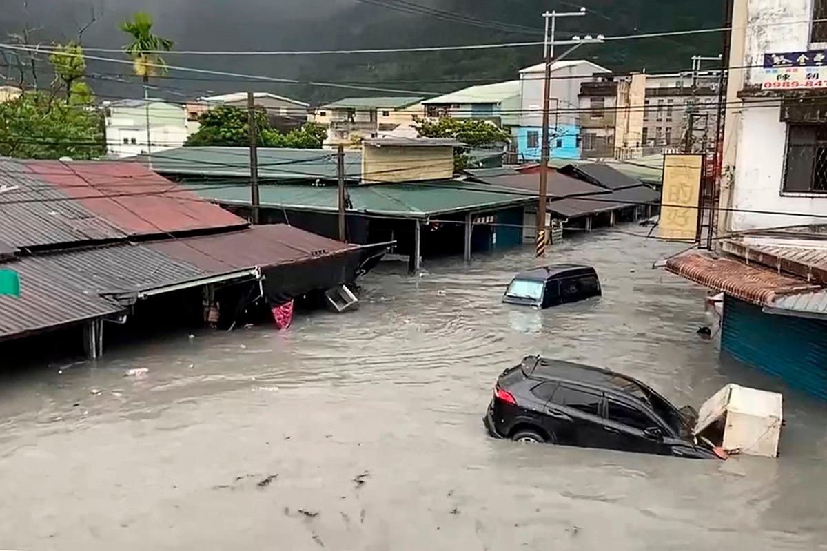 A car is seen stuck in floodwaters in Hualien on September 23, 2025, after a barrier lake burst and flooded the Guangfu township. AFP PHOTO / Taiwan’s Central News Agency (CNA)