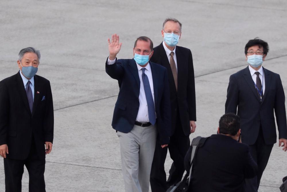 US Health Secretary Alex Azar waves to the journalists as he arrives at Sungshan Airport in Taipei on August 9, 2020. — AFP