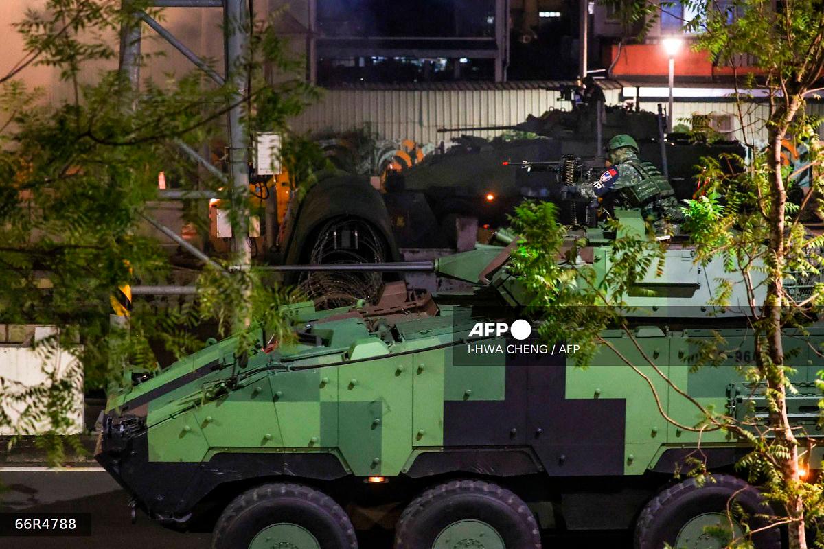 Soldiers riding a CM-34 Clouded Leopard, officially Taiwan Infantry Fighting Vehicle (TIFV), take part in the annual Han Kuang military exercises in Taipei on July 15, 2025. - I-Hwa Cheng / AFP
