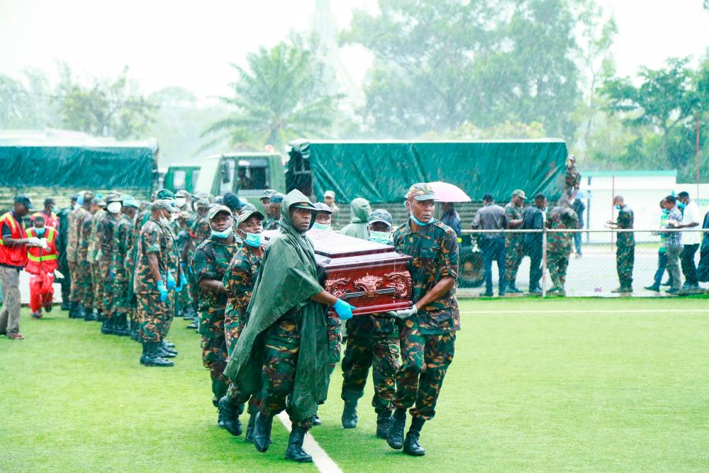 Soldiers carry the casket of a victim, after a passenger plane plunged into Lake Victoria, at the Kaitaba Stadium in Bukoba/AFPPix