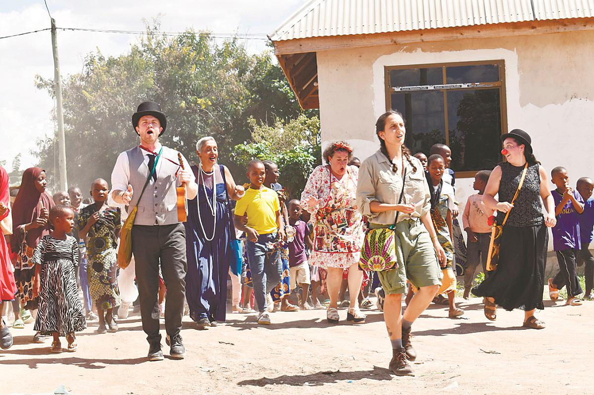 Shantini (left in black dress) and Cinzia (centre, floral dress) members of the group of “ItinerAnts” worked hard to create a magical world for the children in the rural community of Tanzania.
