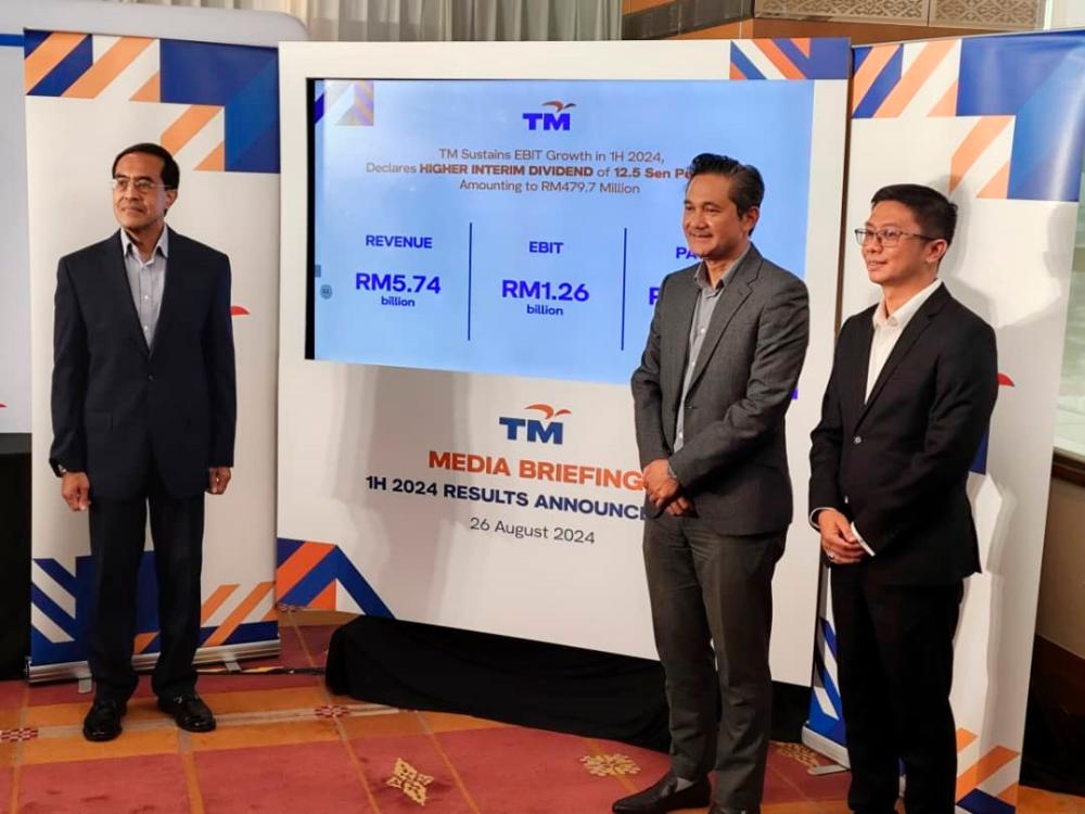 From left: TM chief financial officer Razidan Ghazali, Amar Huzaimi and deputy chief financial officer Fairus Rahim.