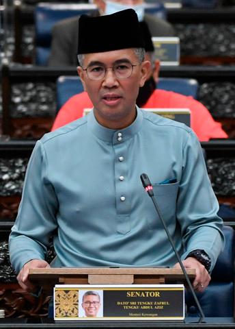 Finance Minister Tengku Datuk Seri Zafrul Abdul Aziz unveils the Budget 2021 yesterday.-Bernama