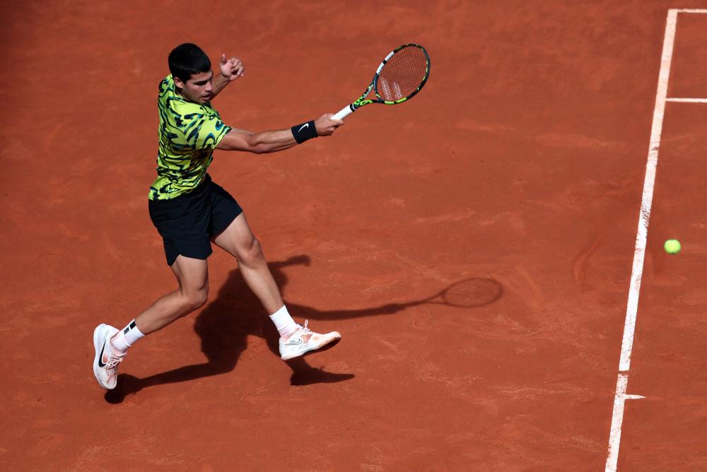 Spain’s Carlos Alcaraz returns the ball to Russia’s Karen Khachanov during their 2023 ATP Tour Madrid Open tennis tournament singles quarter-final match at Caja Magica in Madrid on May 3, 2023/AFPPix