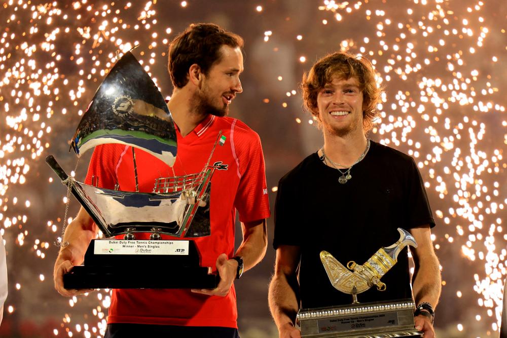 Russia’s Daniil Medvedev (L) and Andrey Rublev pose with their trophies after the former won the ATP Dubai Duty Free Tennis Championship final match in Dubai, on March 4, 2023. AFPPIX