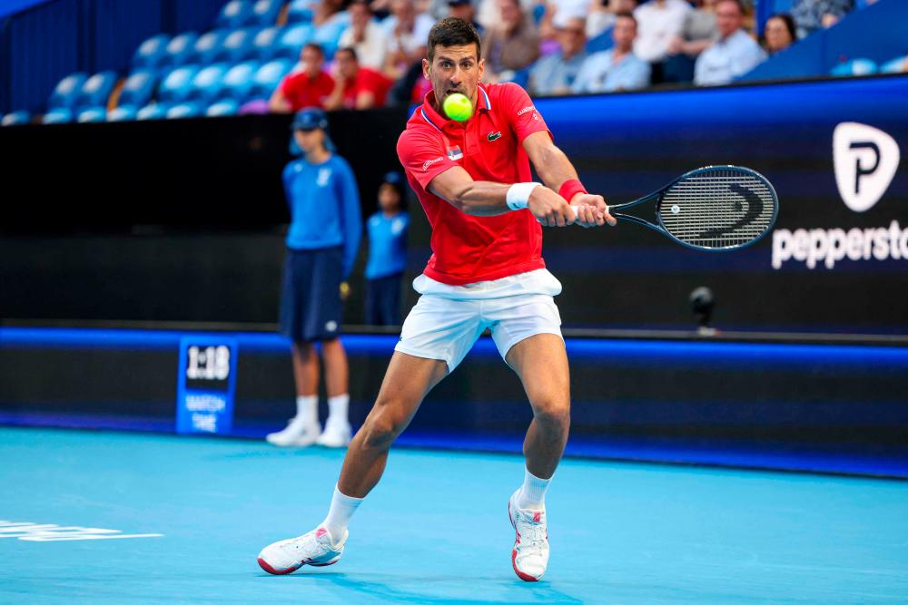 Serbia’s Novak Djokovic hits a return against Australia’s Alex de Minaur during their men’s singles match at the United Cup tennis tournament in Perth on January 3, 2024/AFPPix