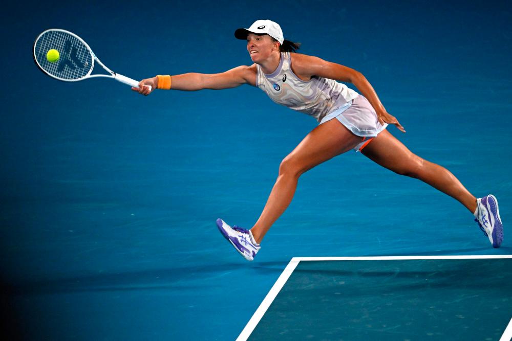 Poland’s Iga Swiatek hits a return against Colombia’s Camila Osorio during their women’s singles match on day three of the Australian Open tennis tournament in Melbourne on January 18, 2023/AFPPix