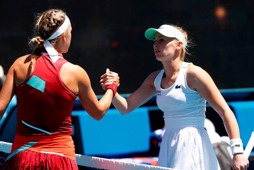 Belarus’ Victoria Azarenka (L) shakes hands with Switzerland’s Jil Teichmann after their women’s singles match on day three of the Australian Open tennis tournament in Melbourne on January 19, 2022. AFPPIX