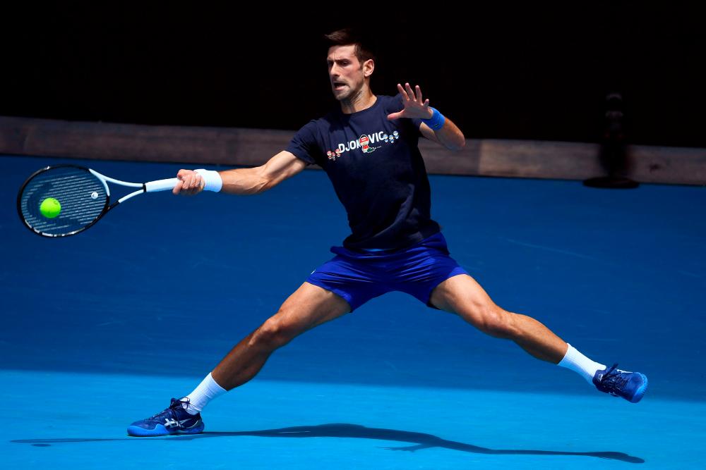 Novak Djokovic of Serbia hits a return during a practice session ahead of the Australian Open at the Melbourne Park tennis centre in Melbourne on January 12, 2022. AFPPIX