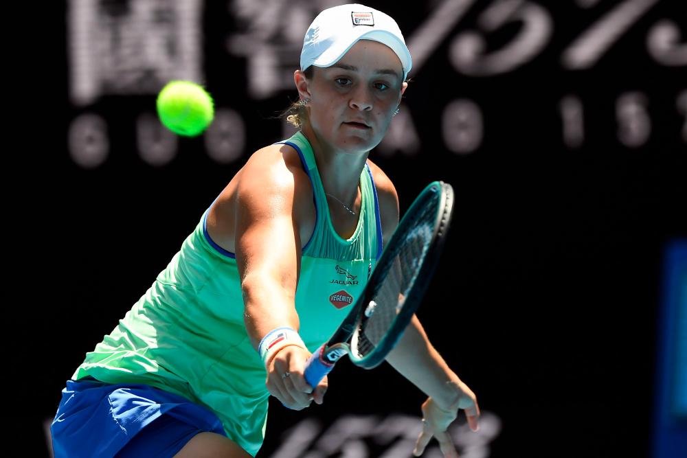 Australia's Ashleigh Barty hits a return against Czech Republic's Petra Kvitova during their women's singles quarter-final match on day nine of the Australian Open tennis tournament in Melbourne on January 28, 2020. - AFP