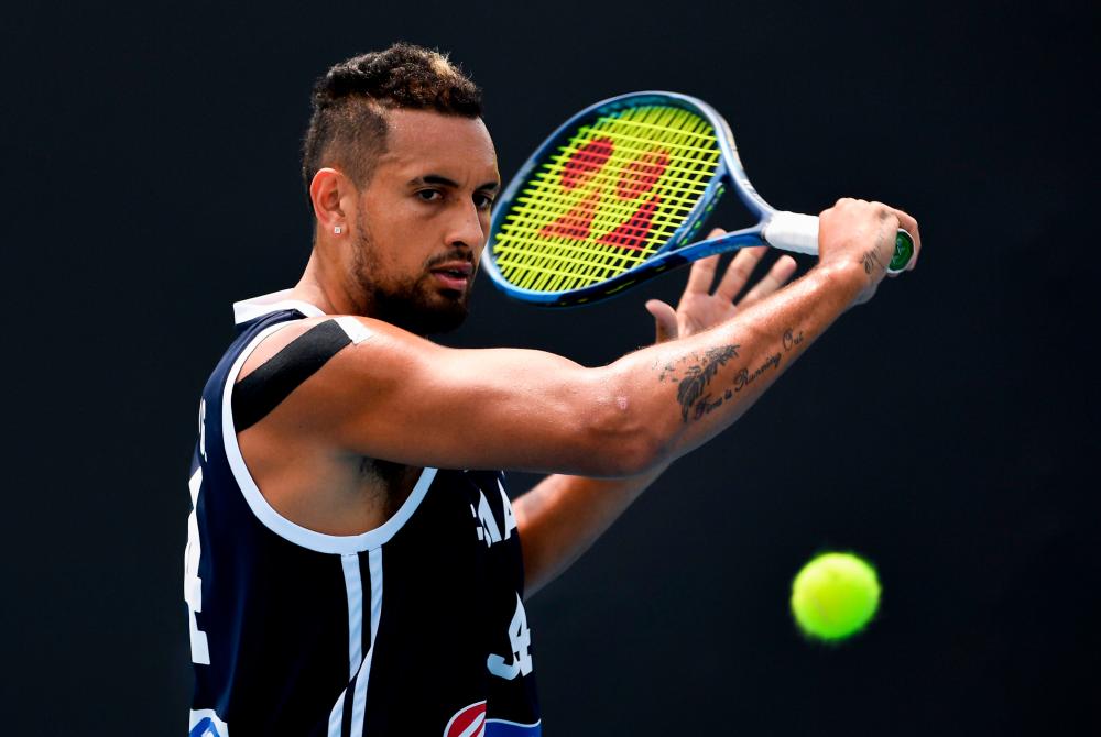 Nick Kyrgios of Australia hits a return during a practice session ahead of the Australia Open tennis tournament in Melbourne on January 18, 2020. - AFP
