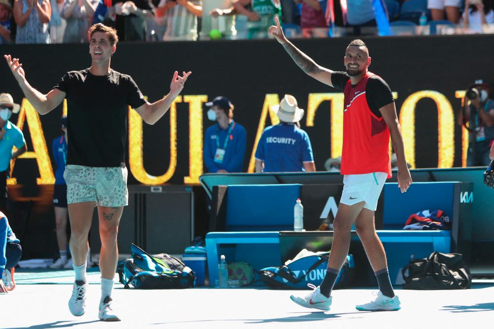 Australia’s Thanasi Kokkinakis (L) and Australia’s Nick Kyrgios react after winning against Spain’s Marcel Granollers and Argentina’s Horacio Zeballos during their men’s doubles semi-final match on day eleven of the Australian Open tennis tournament in Melbourne on January 27, 2022. AFPPIX