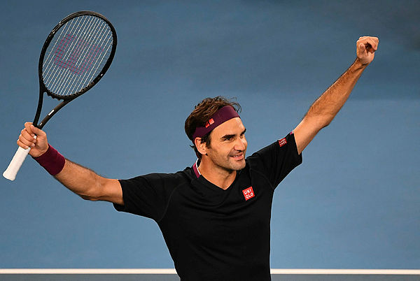 Switzerland’s Roger Federer celebrates after victory against Australia’s John Millman during their men’s singles match on day five of the Australian Open tennis tournament in Melbourne on Jan 24. — AFP