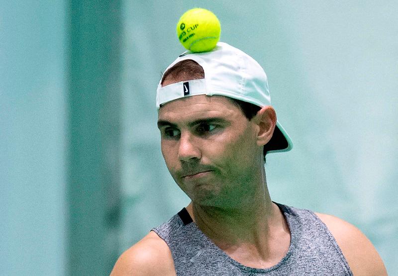 Spain’s tennis player Rafael Nadal heads a ball after tossing it into the air during a training session ahead of the Davis Cup tennis tournament at the Martin Carpena sportshall, in Malaga, on November 17, 2024. - JORGE GUERRERO / AFPpix