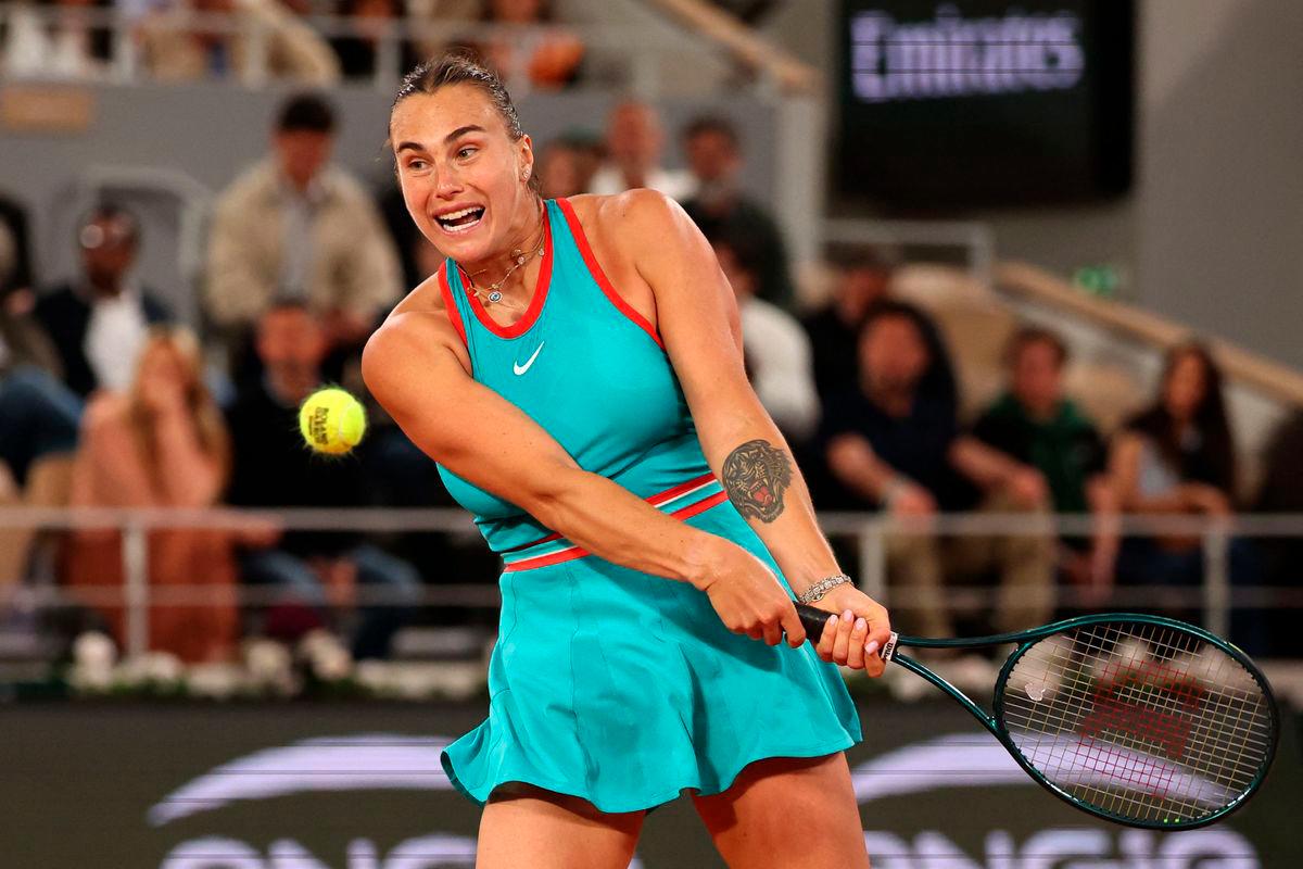 Belarus’ Aryna Sabalenka plays a backhand return to Poland’s Iga Swiatek during their women’s singles semi-final match on day 12 of the French Open tennis tournament on Court Philippe-Chatrier at the Roland-Garros Complex in Paris on June 5, 2025.